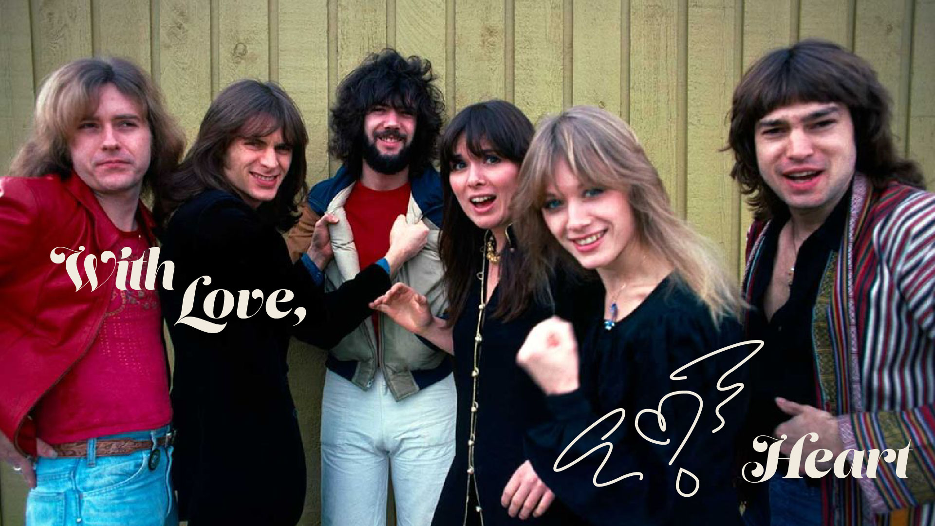Photo from the 70s of all heart band members making silly faces with the text 'with love, Heart' on the image and nancy wilson's signature heart with wings