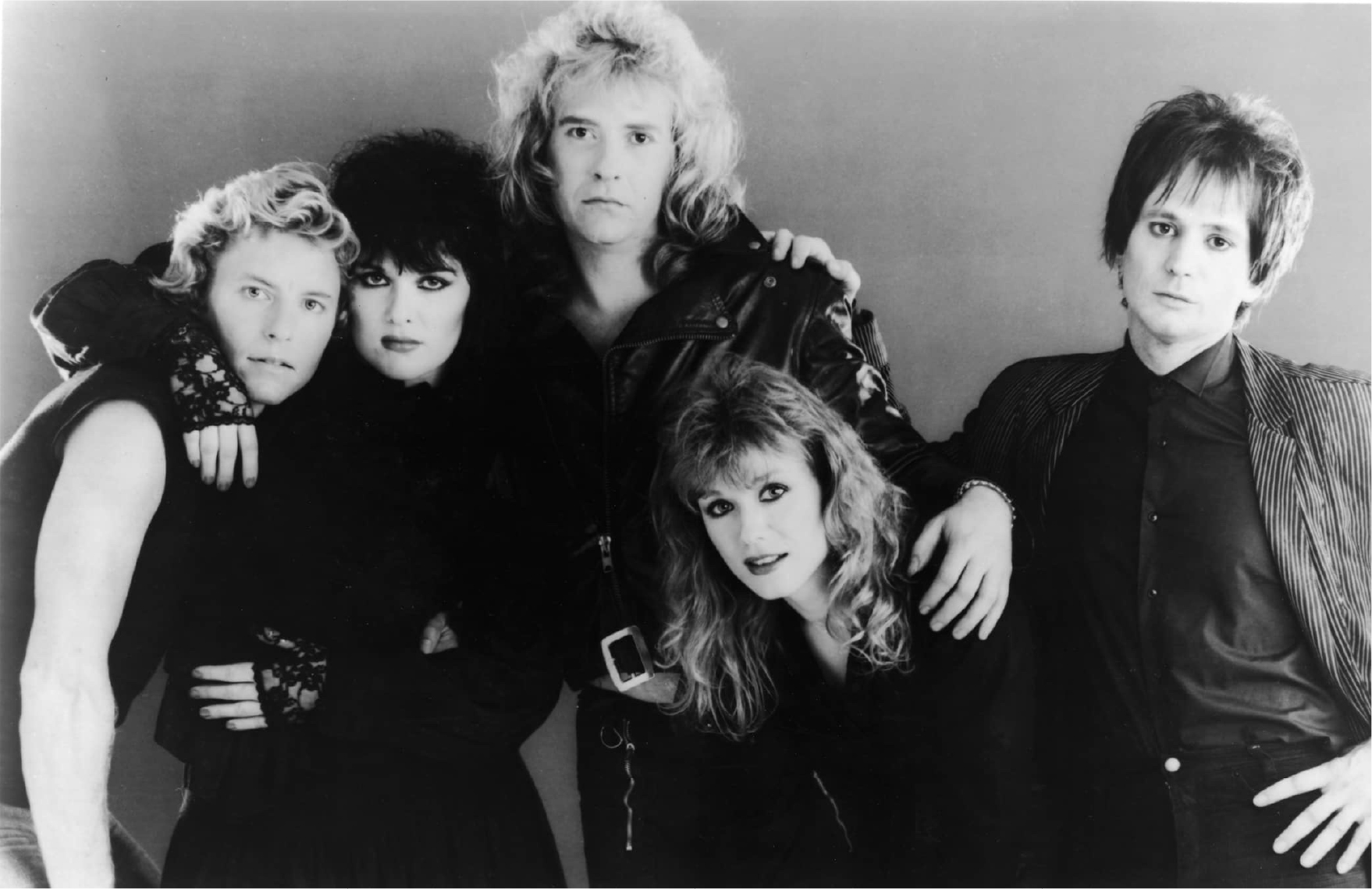 80's black and white studio photo of the band making serious faces