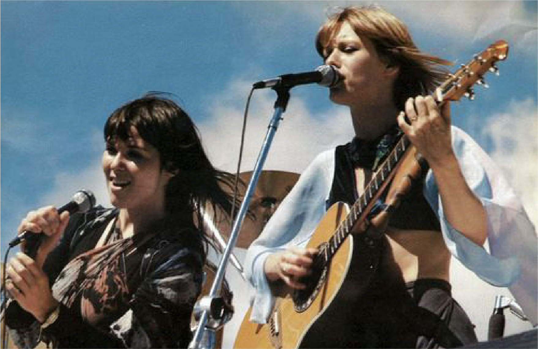 Ann and Nancy performing onstage outside