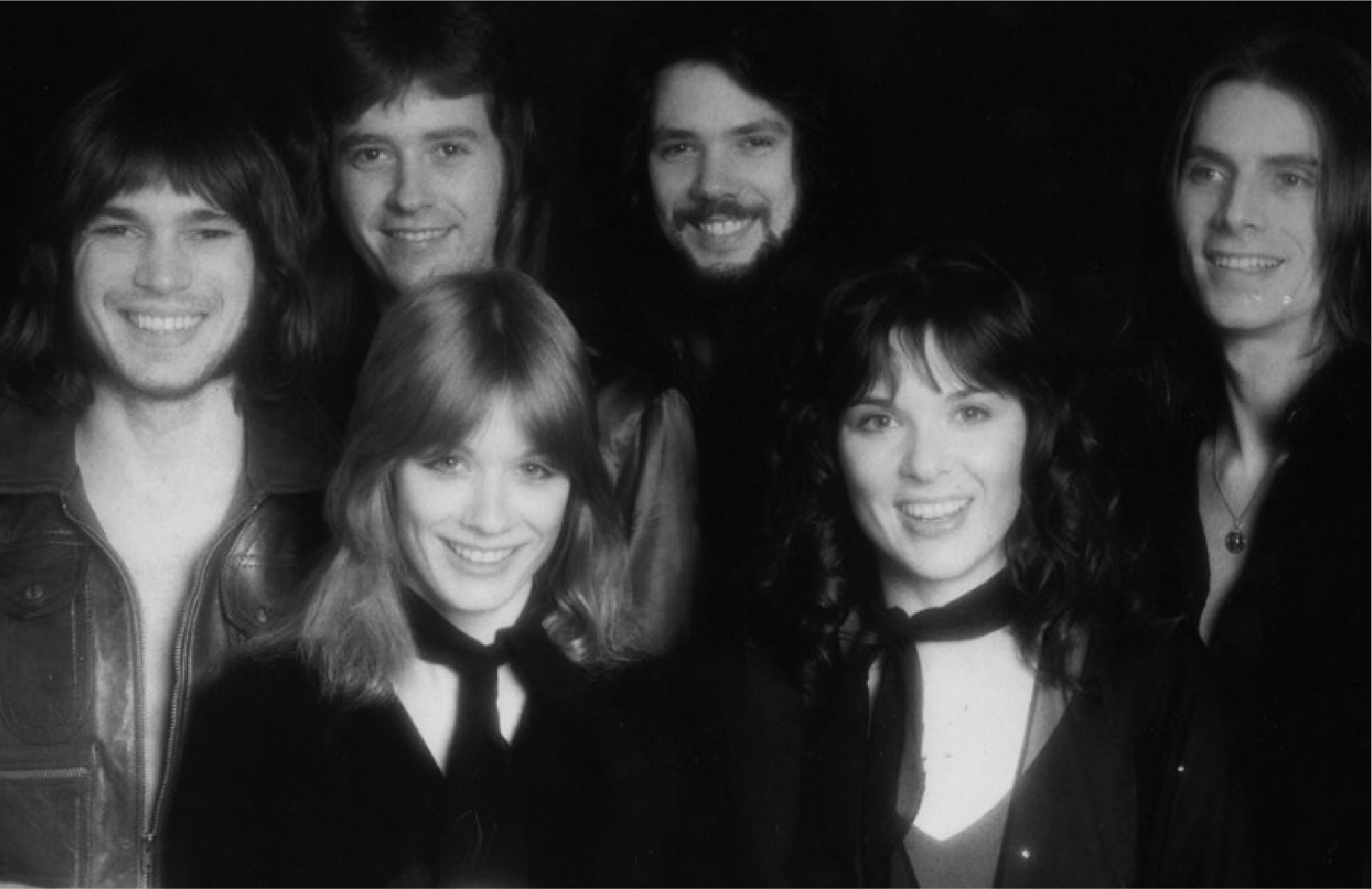 70's black and white studio portrait of the entire band