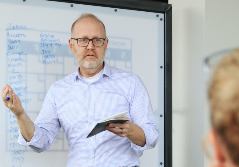 Tom in a design meeting at a whiteboard